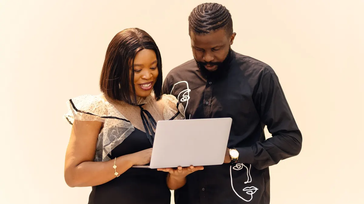 Two professionals learning together on a laptop