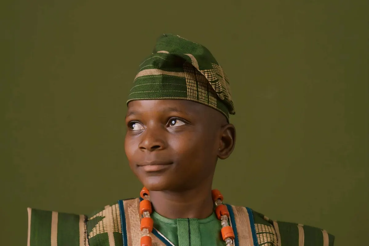 Boy in traditional Yoruba clothes and coral beads